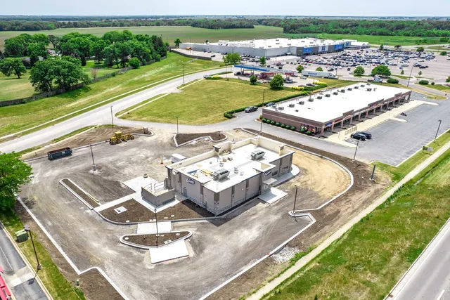 an aerial view of a residential houses with outdoor space and city view