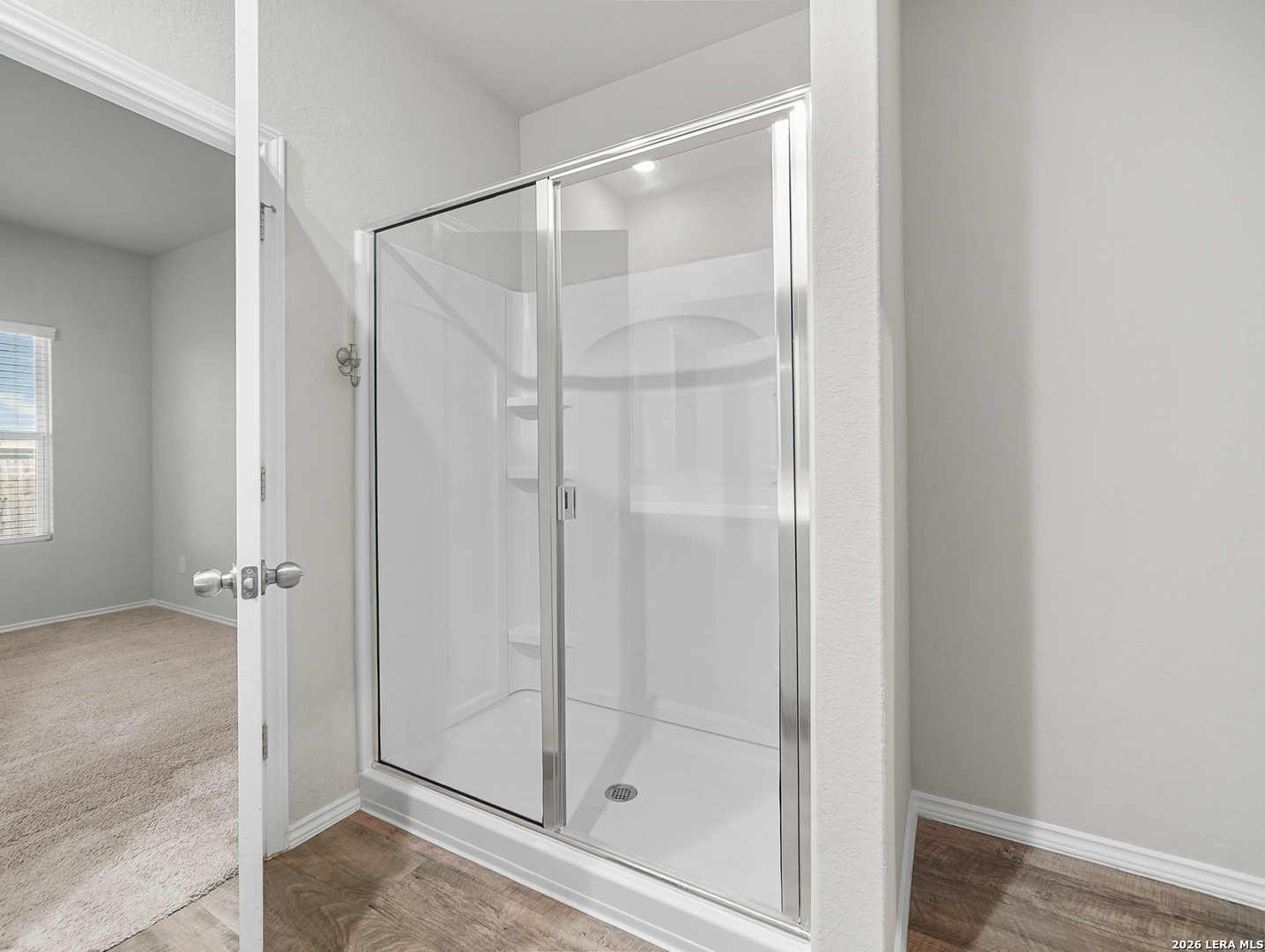 3019 Pacific Coast Converse, TX 78109 - Photo 14 of 31 a bathroom with a glass shower door