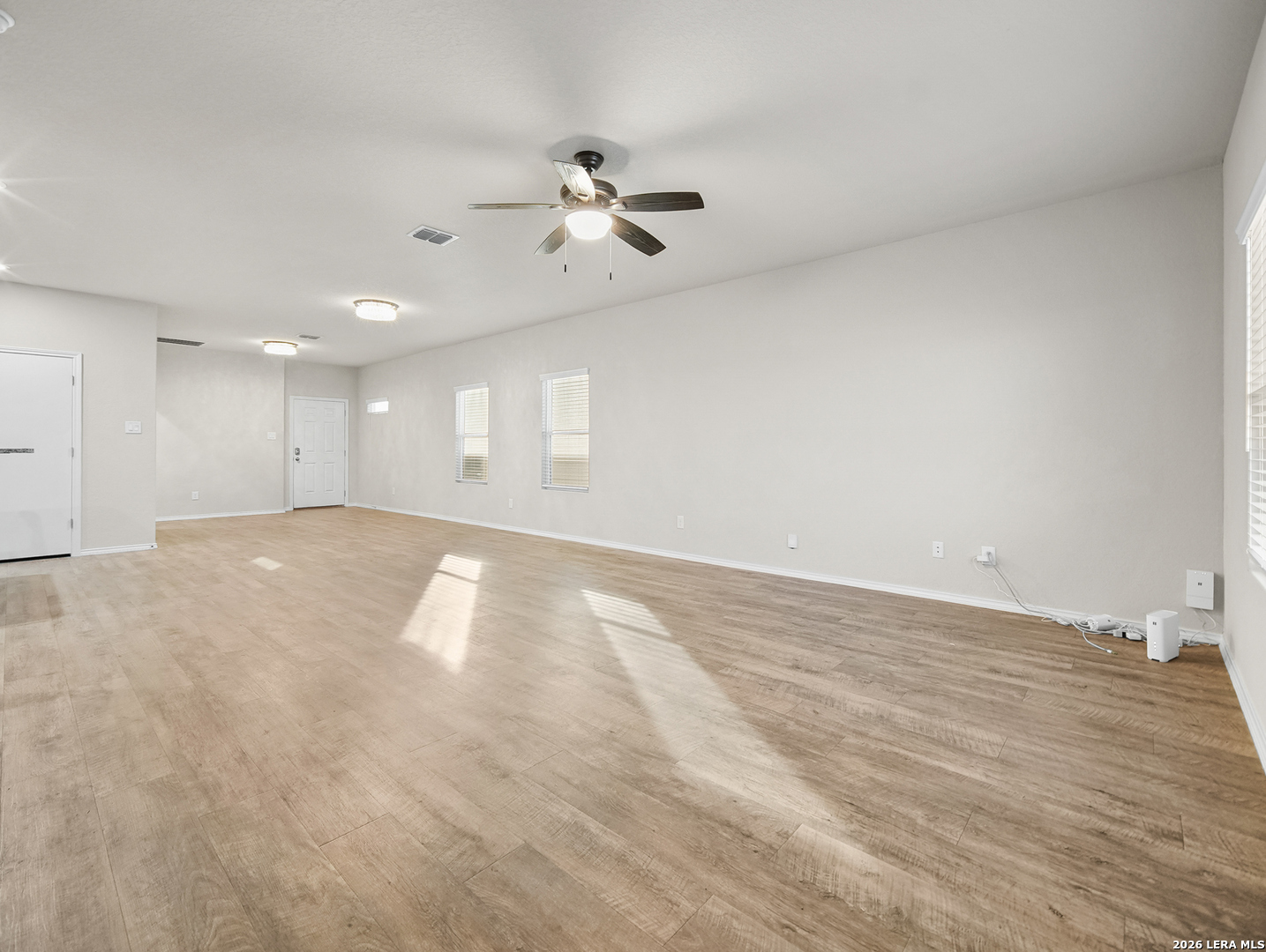 3019 Pacific Coast Converse, TX 78109 - Photo 15 of 31 an empty room with wooden floor and windows