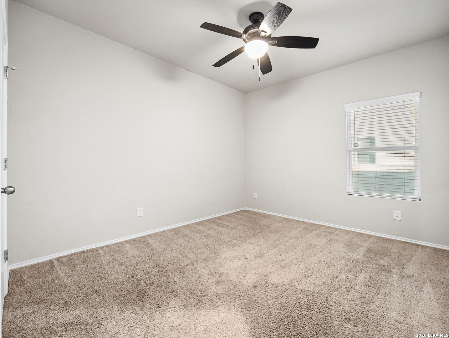 3019 Pacific Coast Converse, TX 78109 - Photo 18 of 31 an empty room with a window and a ceiling fan