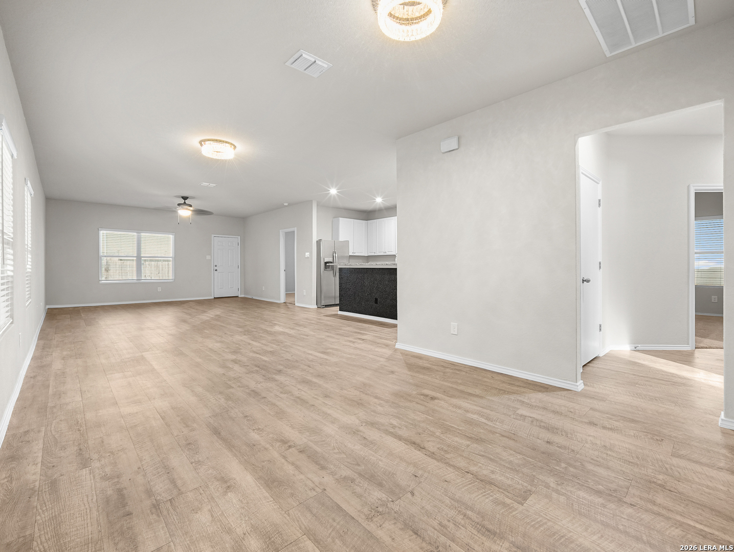 3019 Pacific Coast Converse, TX 78109 - Photo 5 of 31 an empty room with wooden floor and windows