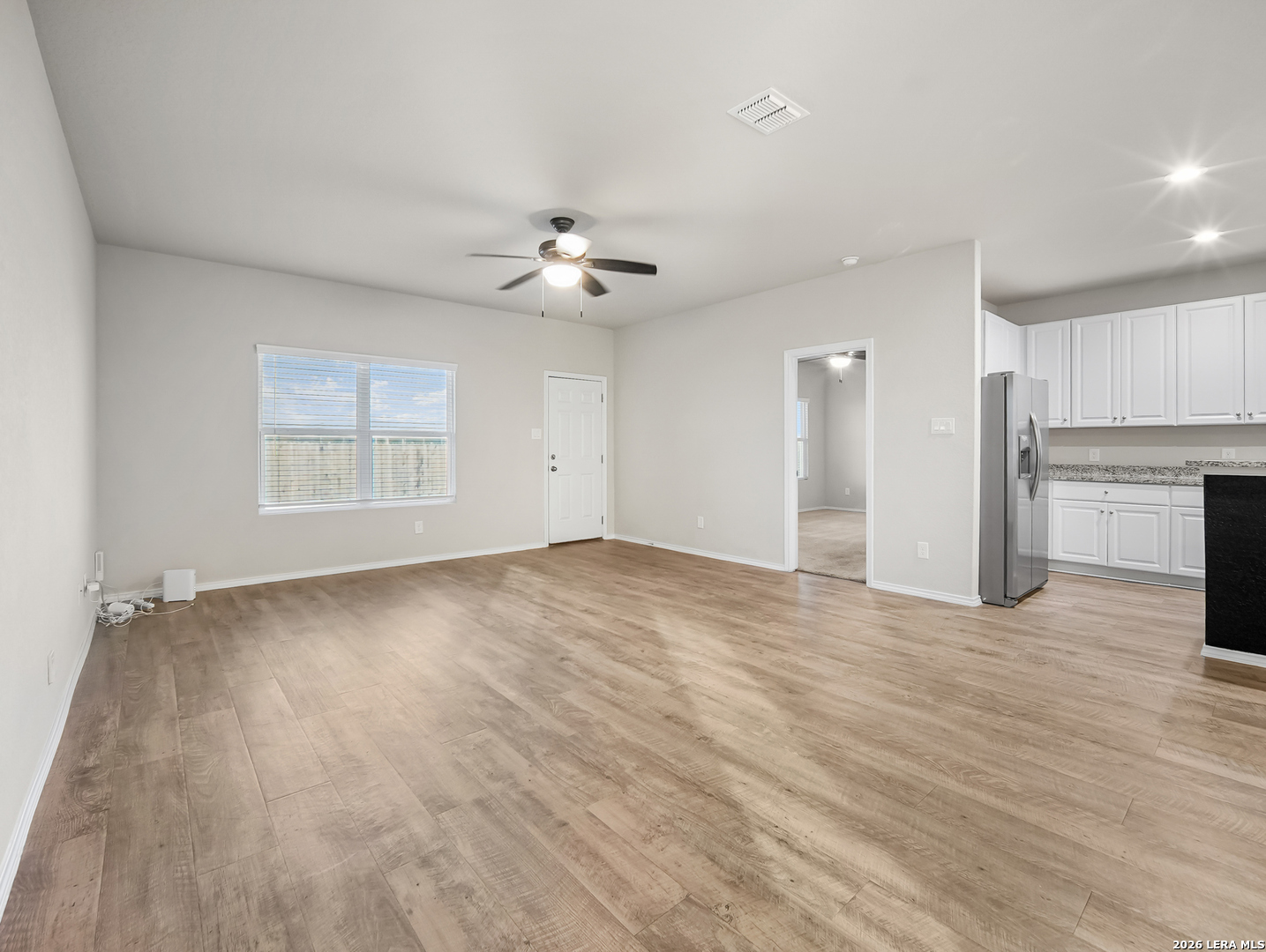 3019 Pacific Coast Converse, TX 78109 - Photo 9 of 31 an empty room with wooden floor ceiling fan and windows