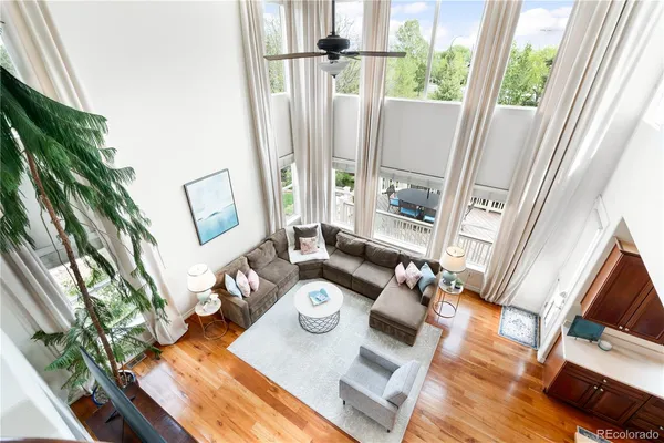 a living room with furniture and a floor to ceiling window