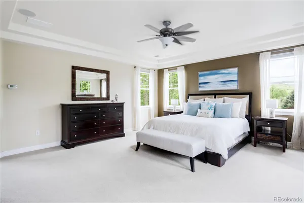 a bedroom with a bed a dresser and a window