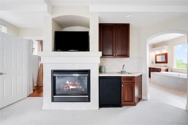 a living room with a fireplace and a flat screen tv