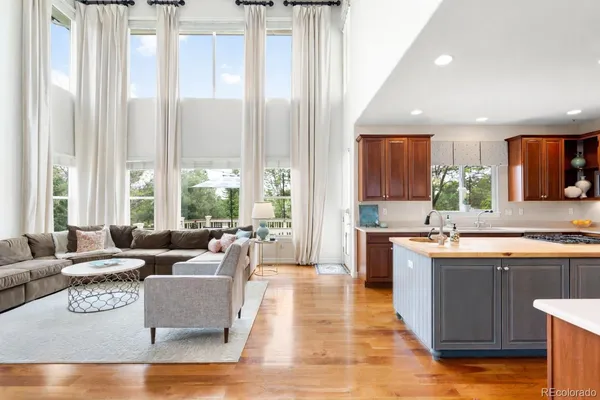 a living room with kitchen island furniture and a large window