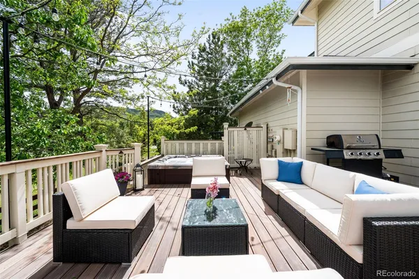 a view of a roof deck with wooden fence and trees