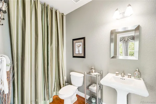 a bathroom with a sink mirror and toilet