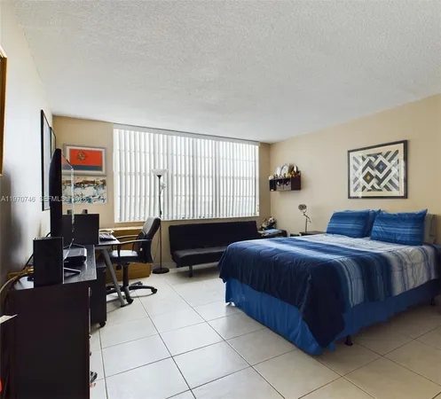 a bedroom with a bed and a desk
