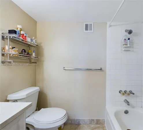 a white toilet sitting next to a bath tub
