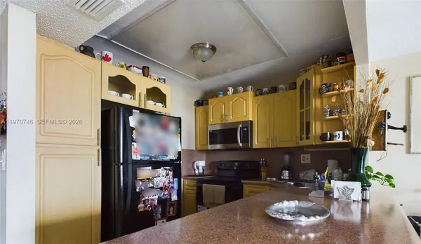a kitchen with stainless steel appliances granite countertop a stove and refrigerator
