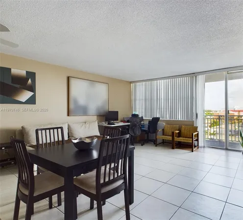 a view of a dining room with furniture and a window