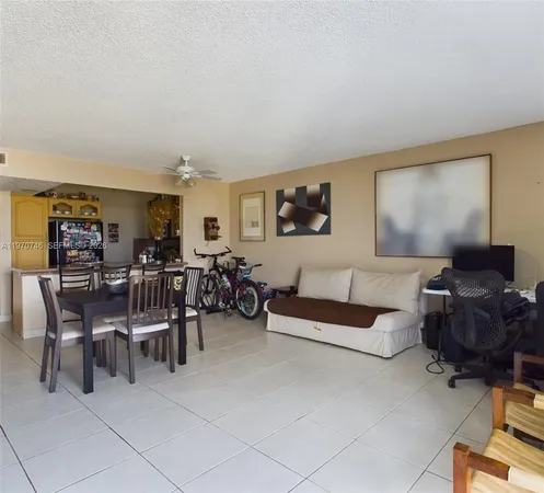 a living room with furniture and a gym machine