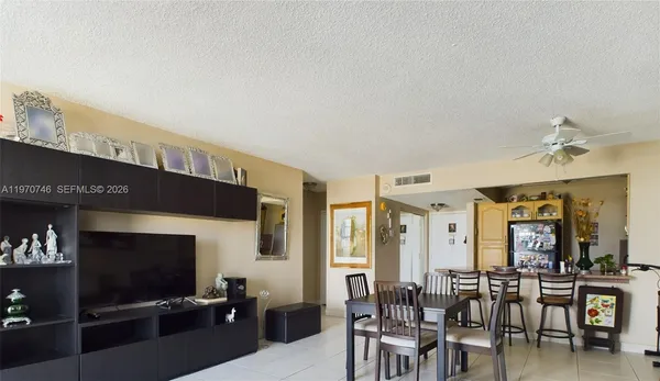 a view of a livingroom with furniture and a flat screen tv