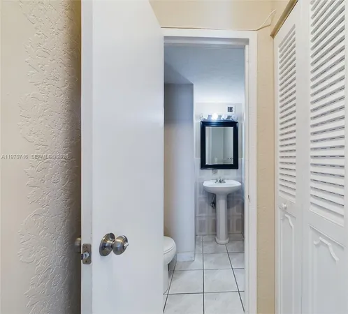 a view of a hallway with a bathroom and a sink