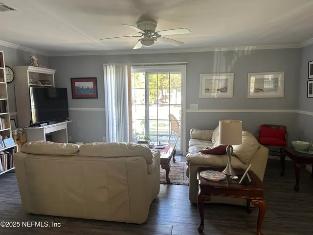 a view of a dining room with furniture and a chandelier