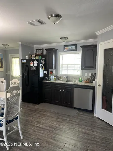a kitchen with a sink and wooden cabinets