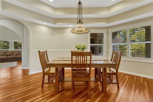 a view of a dining room with furniture window and wooden floor