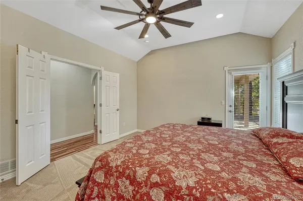 a bedroom with a large bed and a chandelier