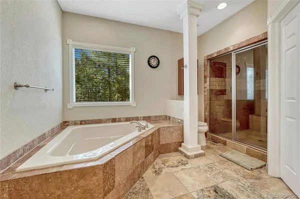 a spacious bathroom with a tub sink and shower