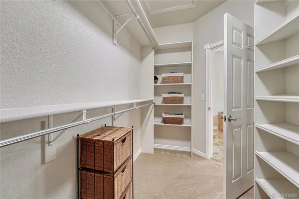 a view of walk in closet with empty racks