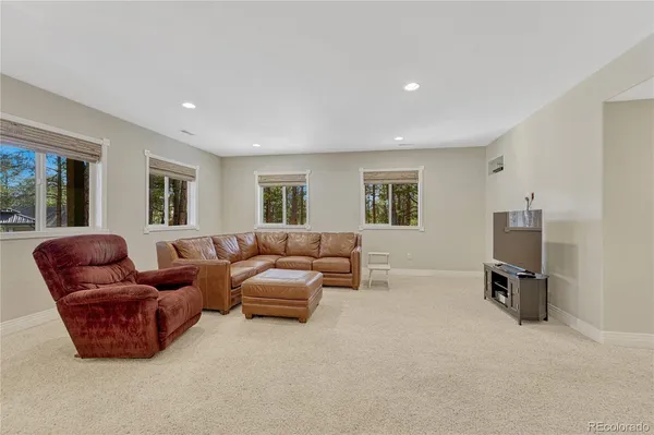 a living room with furniture a couch and a flat screen tv