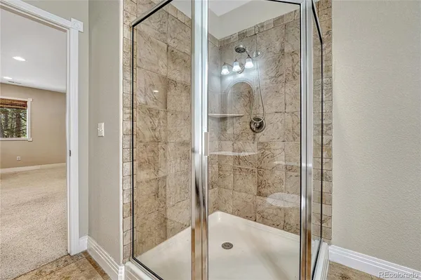 a bathroom with a glass shower door