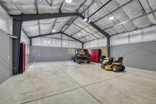a view of garage with cars