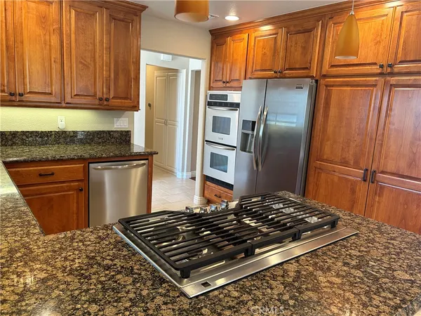 a stove top oven sitting inside of a kitchen
