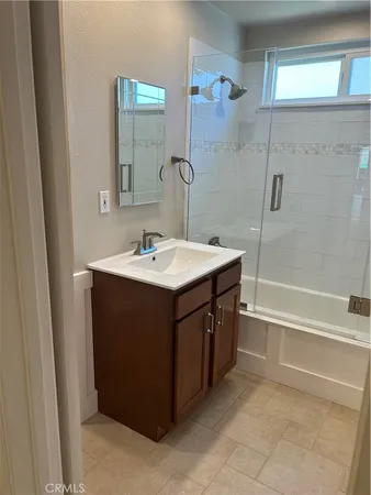 a bathroom with a sink vanity and mirror