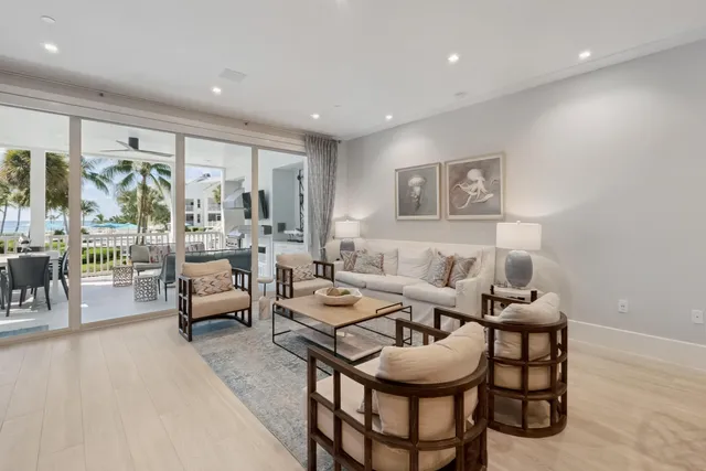 a view of swimming pool with outdoor seating and house in the background