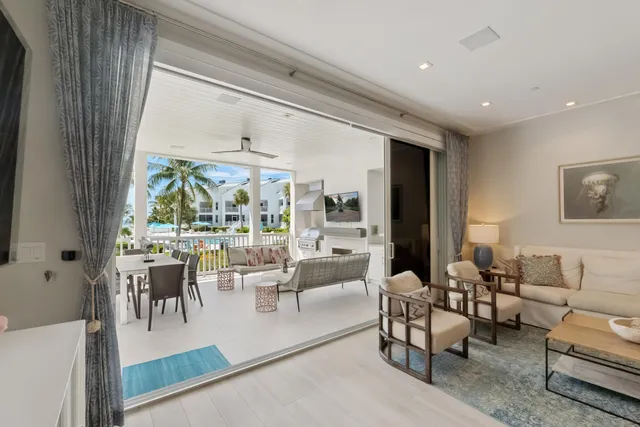 a view of a house with swimming pool and sitting area