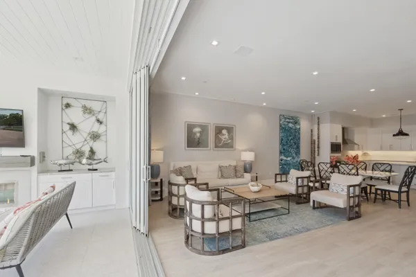 a view of a swimming pool with outdoor seating and plants