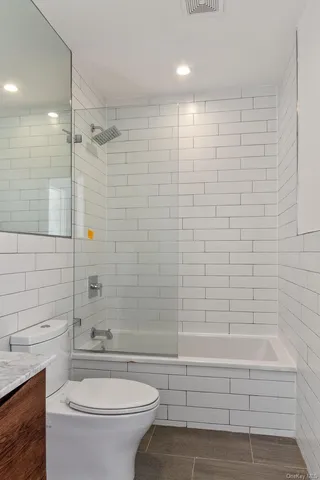 a bathroom with a toilet a sink and bathtub