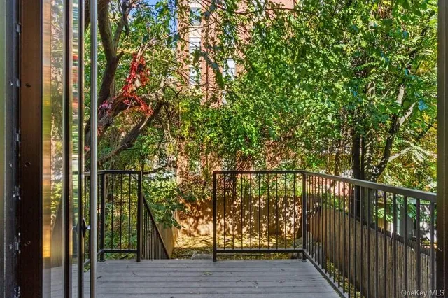 a view of balcony with wooden floor and fence