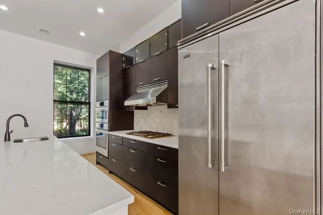 a kitchen with a refrigerator and a stove