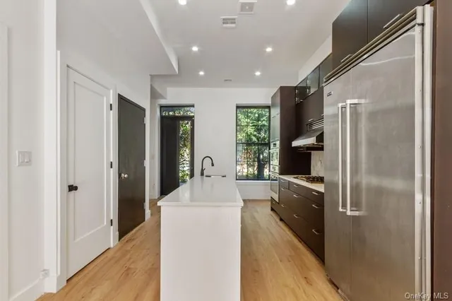 a kitchen with refrigerator and sink
