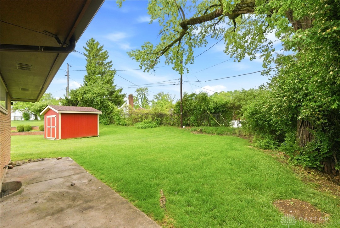 2439 Mayfair Road Dayton, OH 45405 - Photo 38 of 41 This spacious backyard offers a vibrant green lawn and a convenient storage shed.
