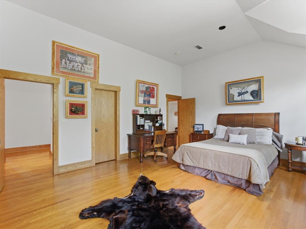 151 Trinity Bluffs Road Aledo, TX 76008 - Photo 27 of 40 a bedroom with bed and a table