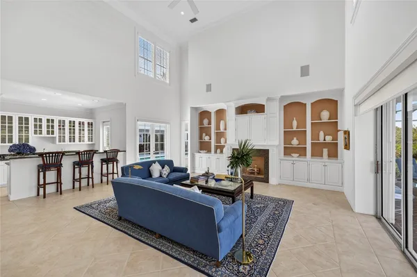 a kitchen with stainless steel appliances granite countertop a table and chairs in it