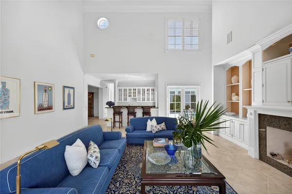 a dining room with furniture a chandelier and wooden floor
