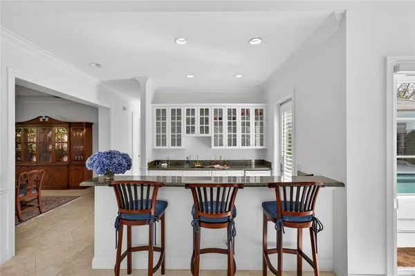 a kitchen with granite countertop a sink stove and refrigerator