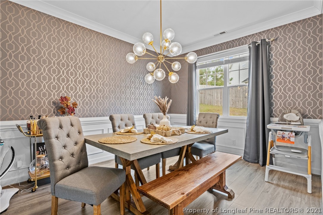 171 Apache Trail Sanford, NC 27332 - Photo 14 of 38 a view of a dining room with furniture a chandelier and wooden floor