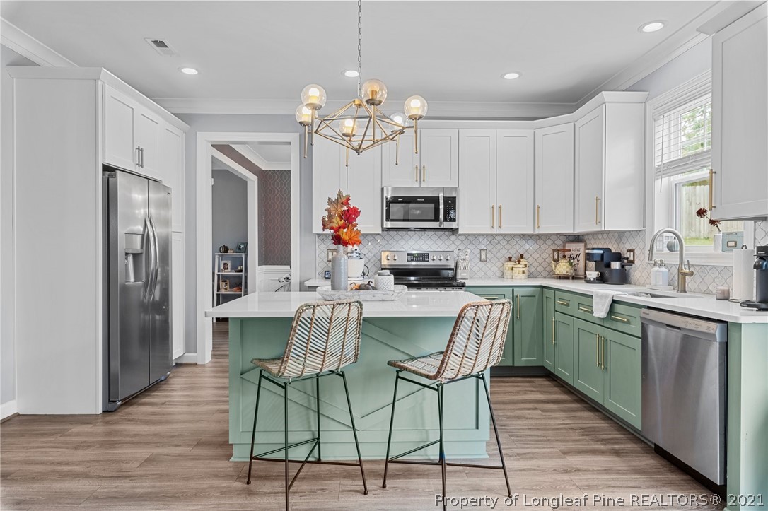 171 Apache Trail Sanford, NC 27332 - Photo 15 of 38 a kitchen with kitchen island granite countertop lots of counter top space and stainless steel appliances