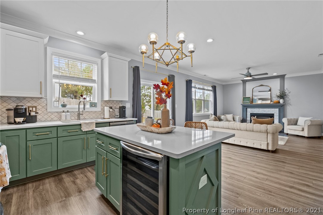 171 Apache Trail Sanford, NC 27332 - Photo 16 of 38 a kitchen with kitchen island granite countertop a sink stove and cabinets