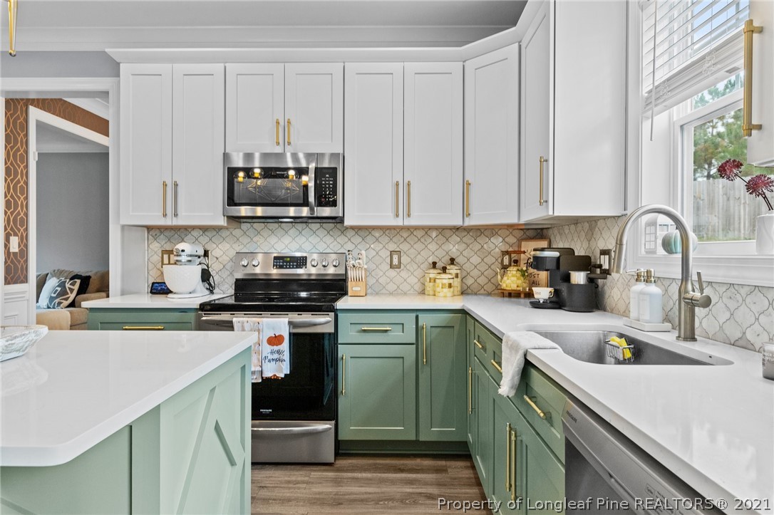 171 Apache Trail Sanford, NC 27332 - Photo 17 of 38 a kitchen with cabinets a sink and appliances
