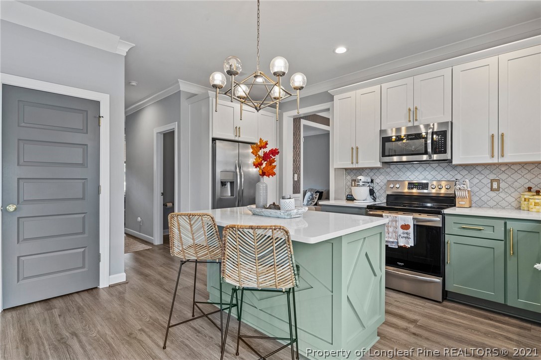 171 Apache Trail Sanford, NC 27332 - Photo 18 of 38 a kitchen that has a cabinets a sink and chairs