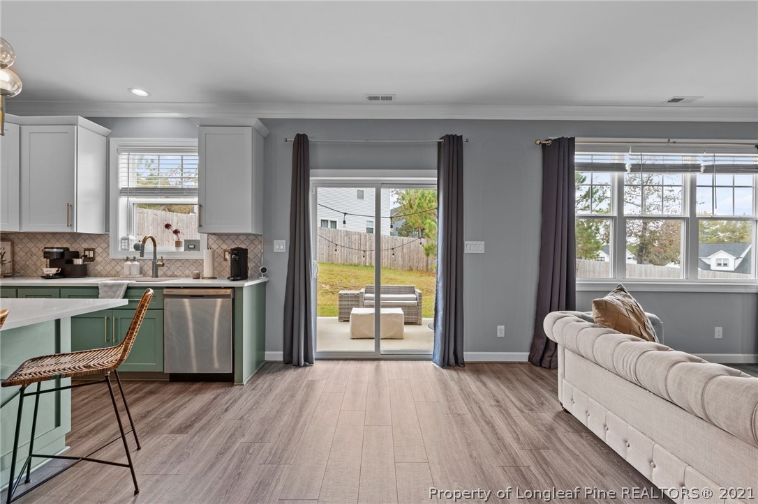 171 Apache Trail Sanford, NC 27332 - Photo 19 of 38 a kitchen with a table chairs refrigerator and window