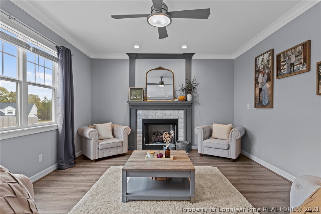 171 Apache Trail Sanford, NC 27332 - Photo 20 of 38 a living room with furniture a chandelier and a fireplace