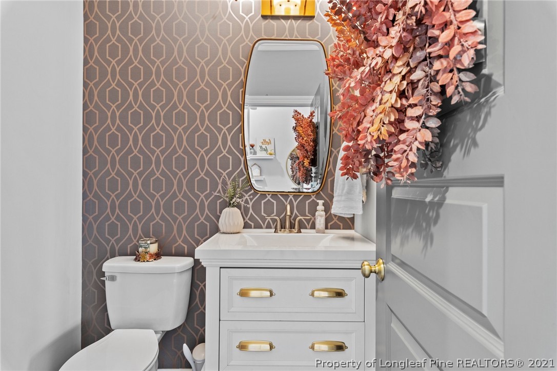 171 Apache Trail Sanford, NC 27332 - Photo 23 of 38 a bathroom with a toilet and a sink